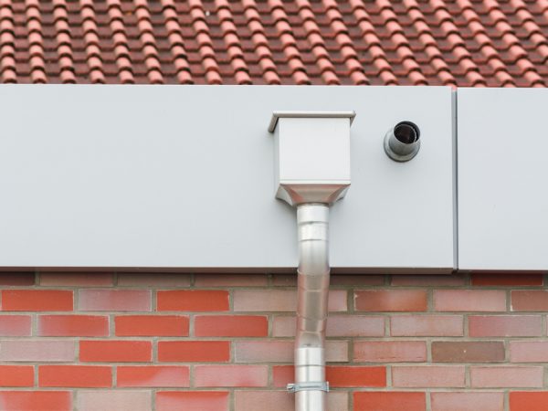 A gutter on the side of a house