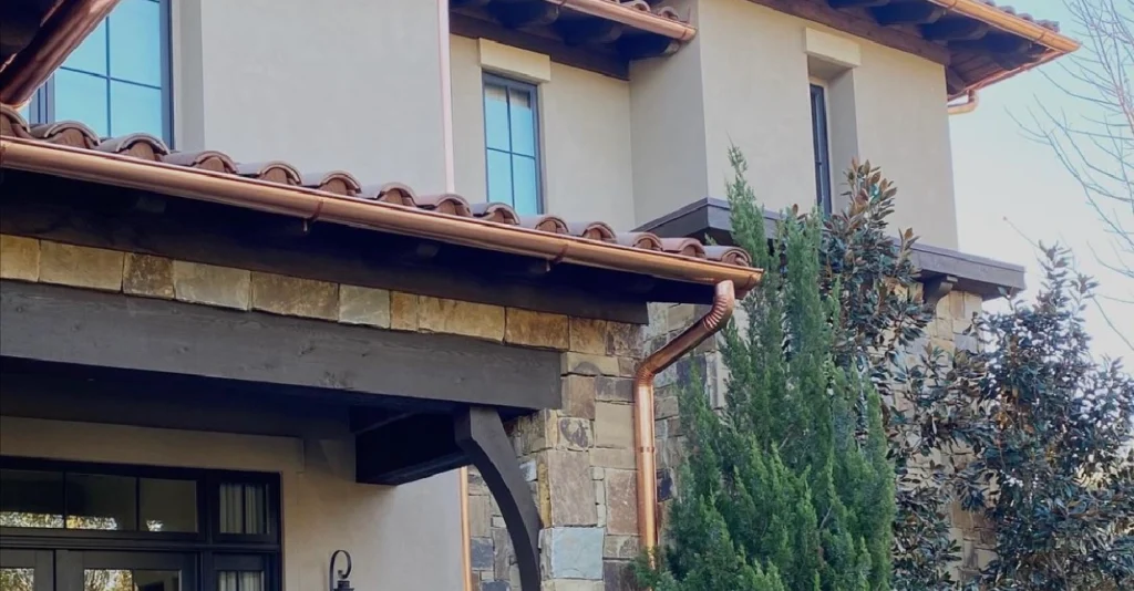 A close up of the side of a house with a gutter