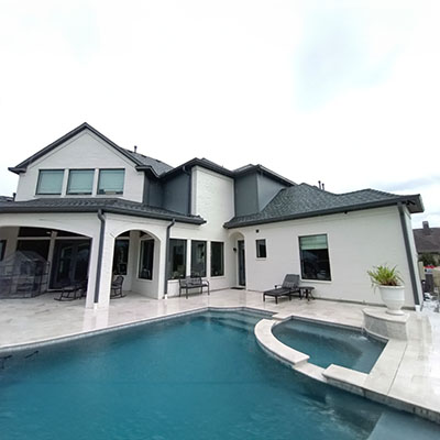 A large pool with a nice view of the house.